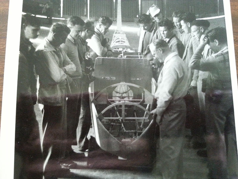 2 Alan and mates around a wooden fuselage under construction. Alan is at the front right smiling as per usual